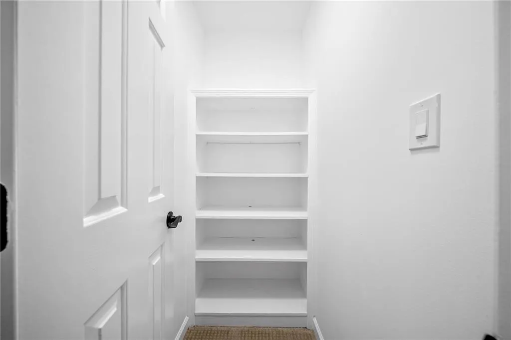 Storage closet upstairs with built-ins
