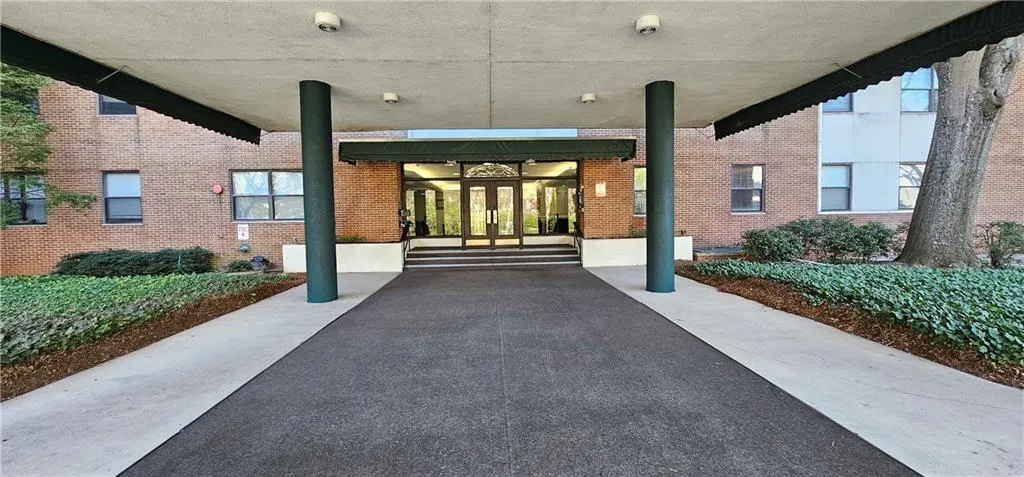 Property entrance featuring french doors and brick siding Property entrance featuring french doors and brick siding