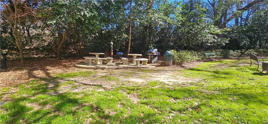 View of yard featuring a patio area and view of wooded area View of yard featuring a patio area and view of wooded area