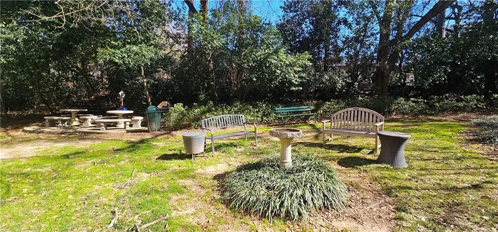 View of green lawn with an outdoor fire pit View of green lawn with an outdoor fire pit