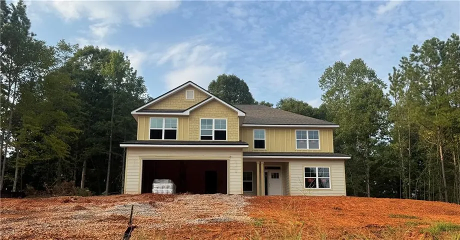 Actual Home- Two-story residence with a two-car garage, featuring hardi-plank siding & Large lot