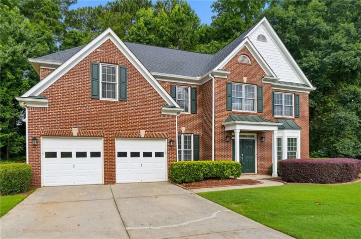 Brick exterior with a dark roof and white trim