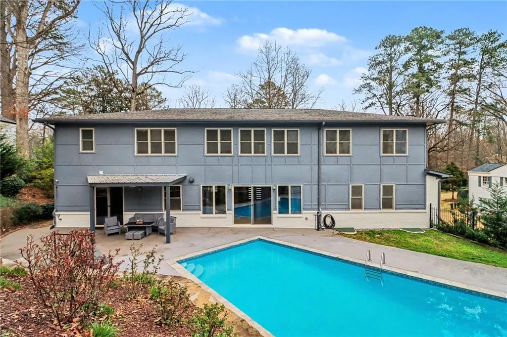 Rear view of house with a patio and an outdoor fire pit