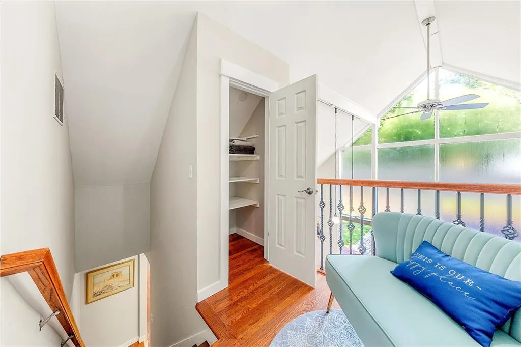 Living room featuring high vaulted ceiling and wood finished floors