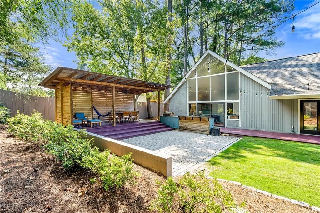 Wooden deck featuring a patio area and a fenced backyard