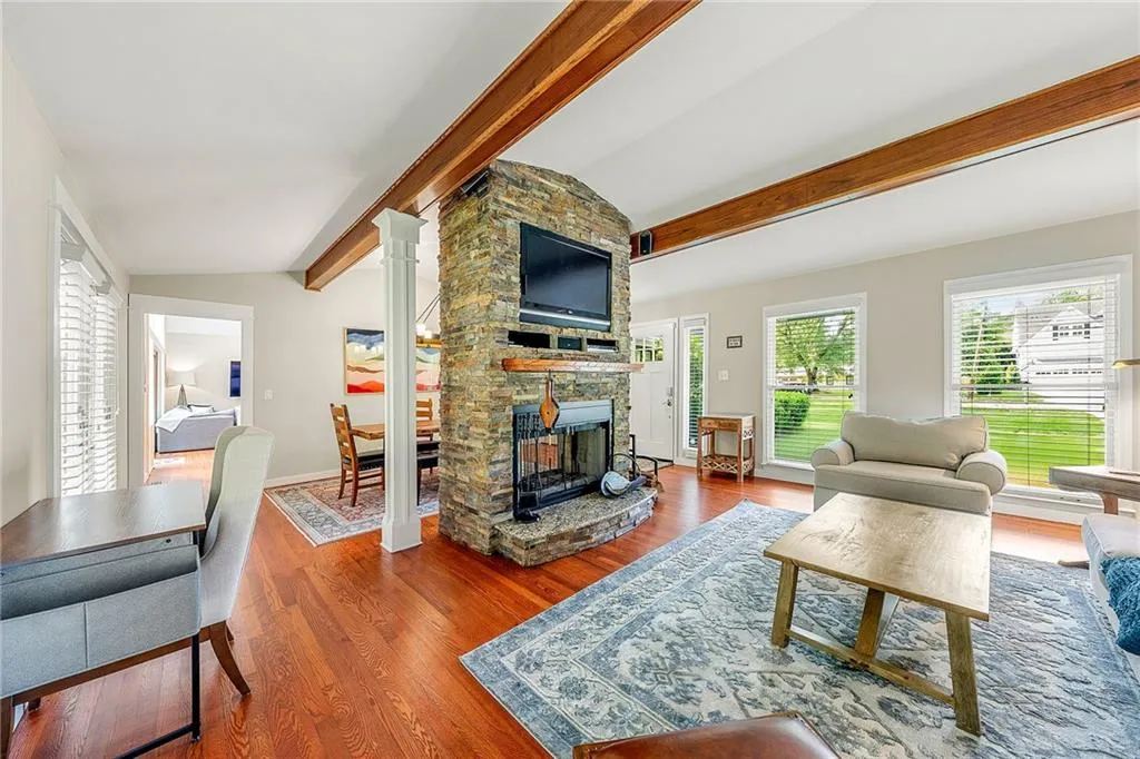 Living room featuring wood finished floors and a fireplace