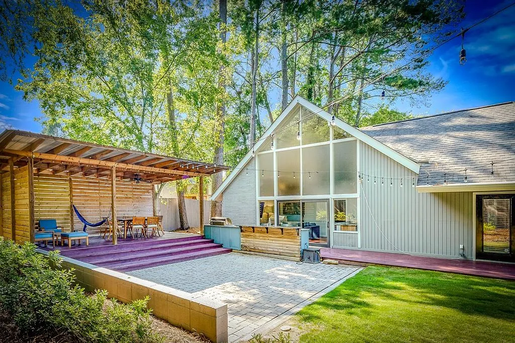 View of green lawn featuring view of scattered trees