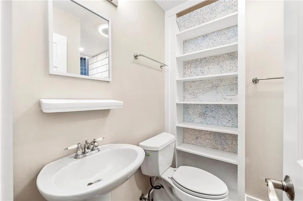 Staircase with wood finished floors and baseboards