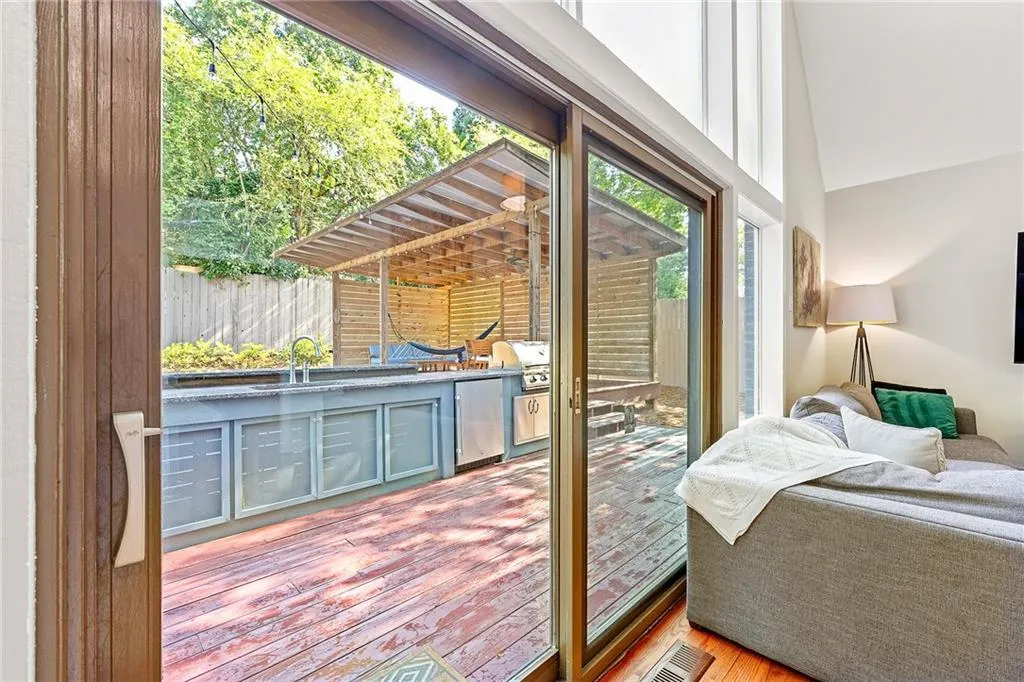 Deck featuring a fenced backyard, outdoor dining space, area for grilling, and a ceiling fan