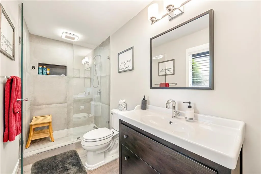 2nd Master Bathroom with vanity, tiled shower, and LVP finished floors