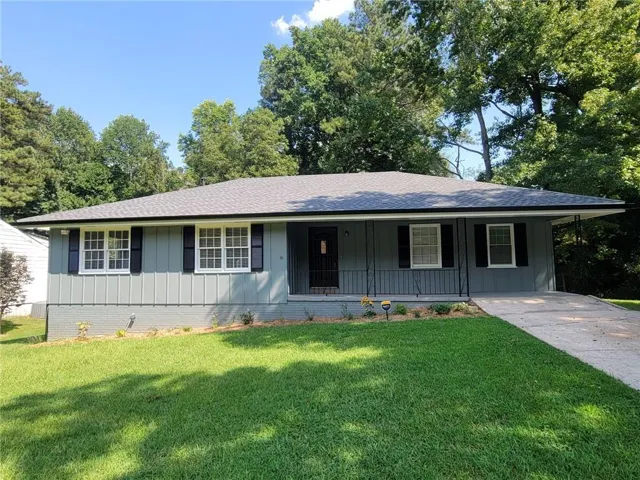 Ranch-style exterior with gray siding and black shutters