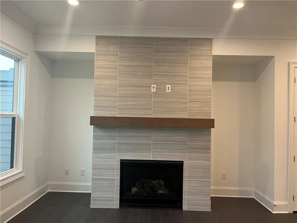 Don't miss the tiled to ceiling fireplace with free floating mantel.