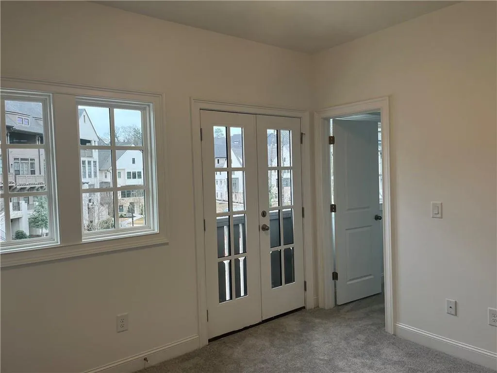 The upstairs secondary bedroom has lots of natural light! Enjoy the walk in closet.