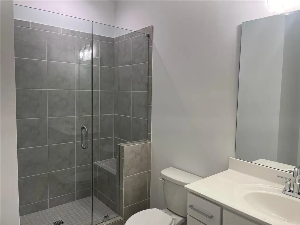 The terrace bedroom features tiled walk in shower with frameless door.