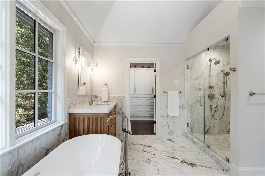 New primary bath with heated floors, double shower.