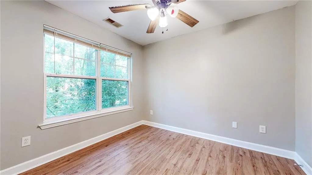Spare room with light wood-style flooring and ceiling fan