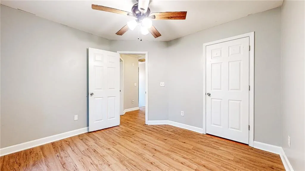 Unfurnished bedroom featuring light wood-type flooring and ceiling fan