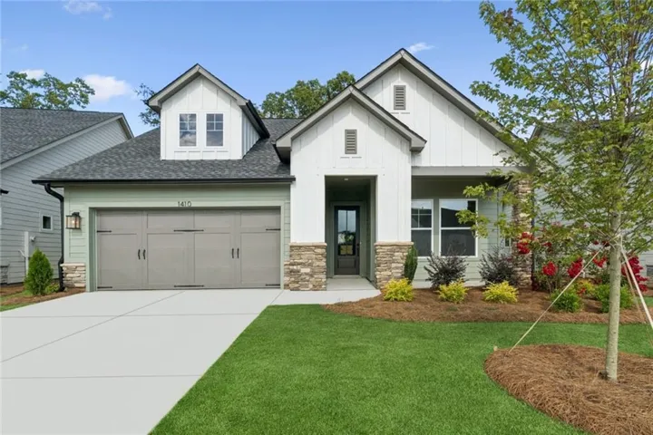 Mint green siding with white board-and-batten gables and stone accents