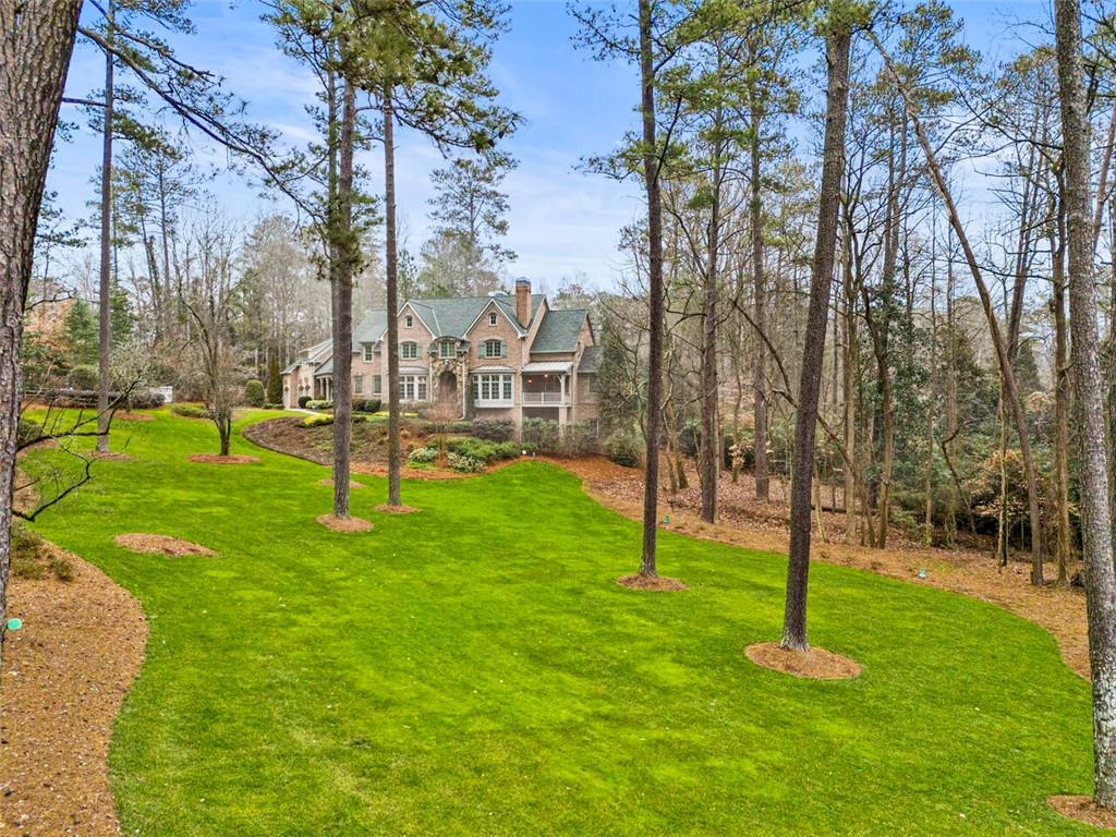 Deep setback off the road with a park like setting