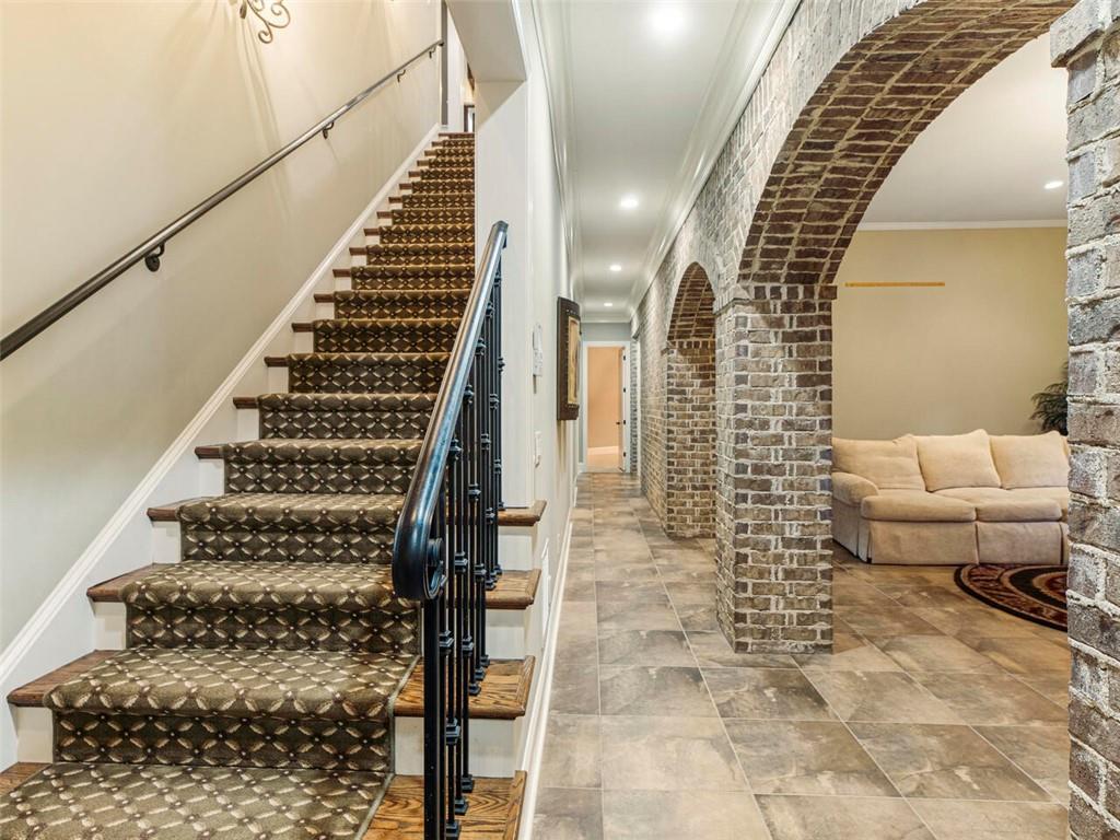 Gorgeous Mediterranean arches add ambiance to the lower level with 14 foot ceilings throughout