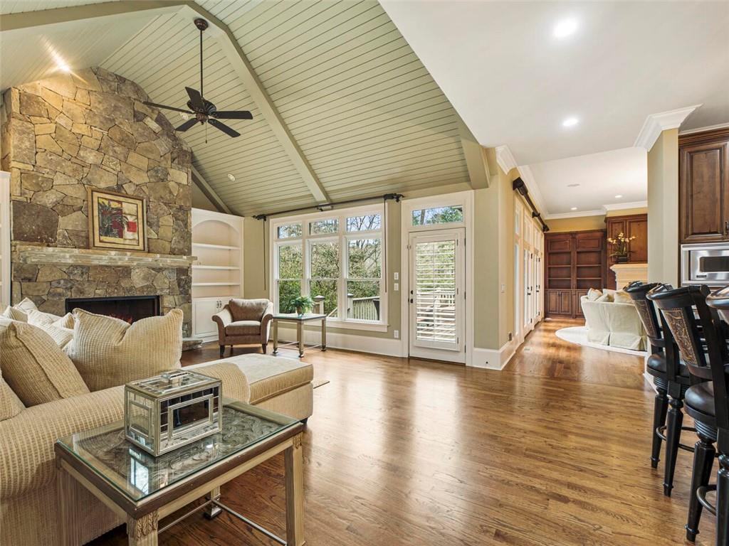 Cozy stone fireplace and built ins. Walk out to deck and pool/spa