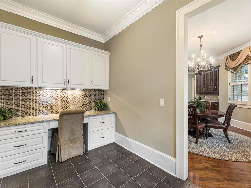 Generous sized mudroom with two entries, built in desk and storage units