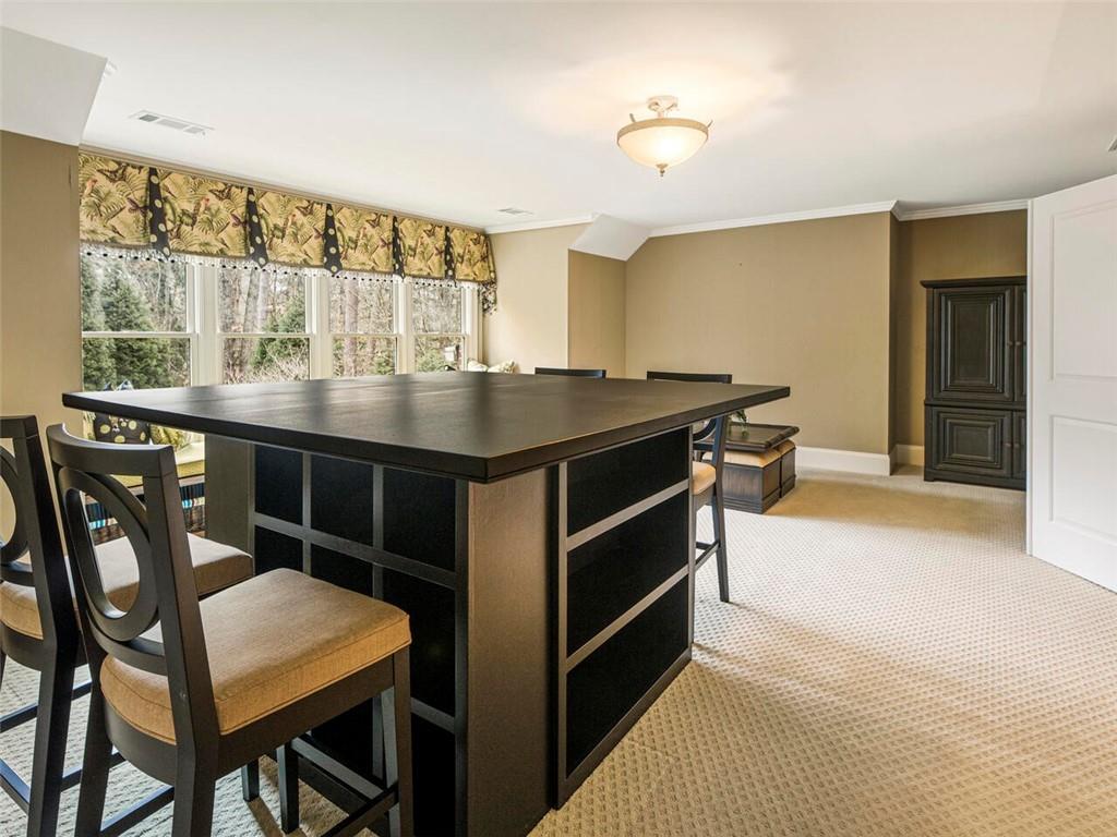 Media/craft room with built in window seating creating a cozy reading nook