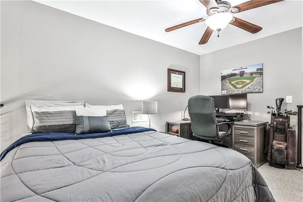 Bedroom featuring ceiling fan and light colored carpet