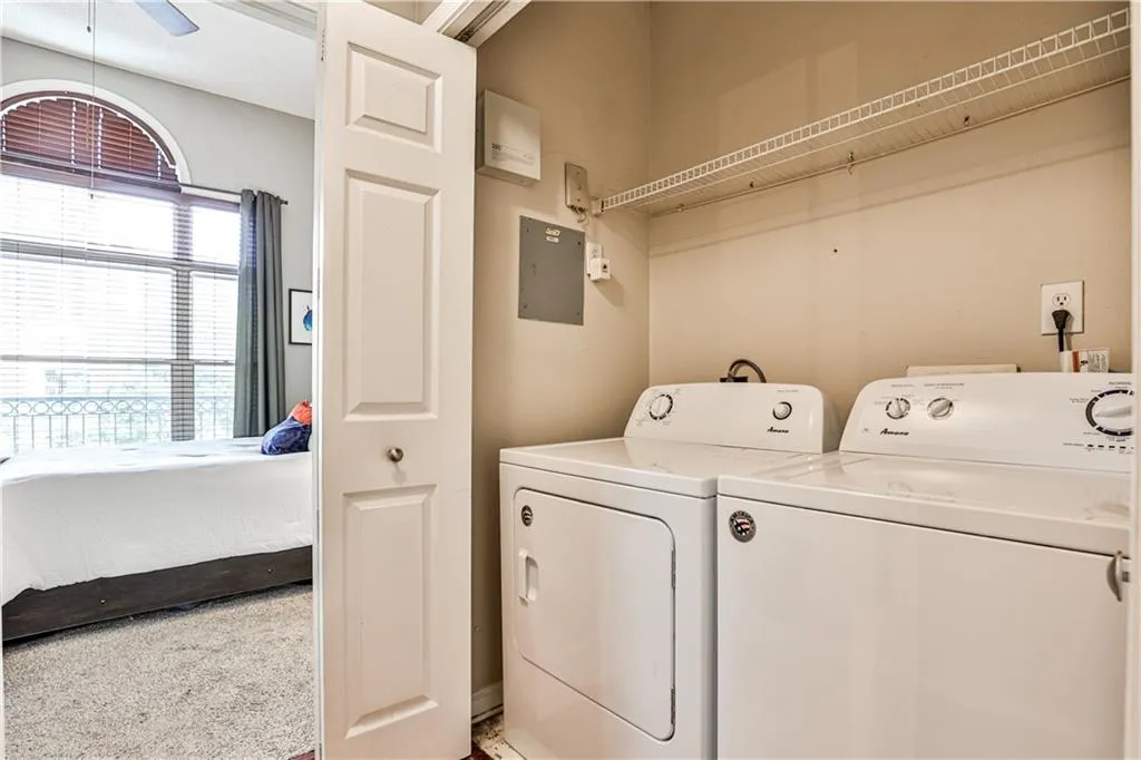 Clothes washing area with ceiling fan, electric panel, laundry area, and independent washer and dryer