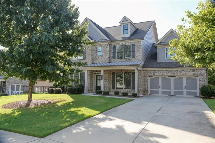 Brick and siding exterior with a covered porch entry