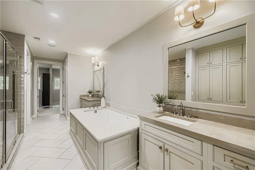 Bathroom featuring vanity, a shower stall, a bath, crown molding, and tile patterned flooring