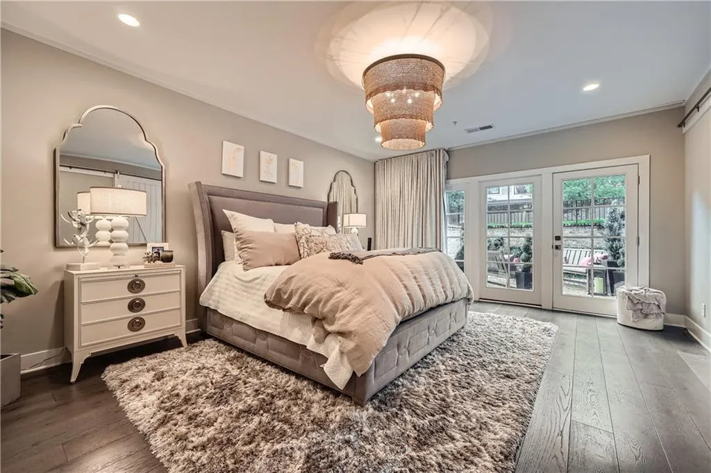 Bedroom featuring access to outside, wood-type flooring, crown molding, and recessed lighting