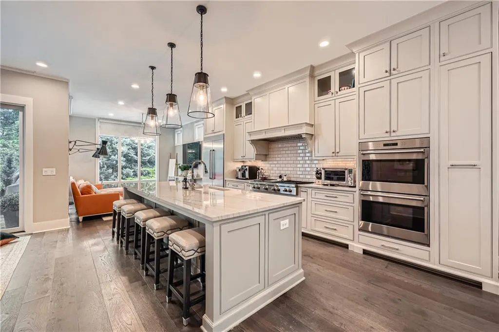Kitchen with stainless steel appliances, dark wood-style floors, recessed lighting, backsplash, and healthy amount of natural light