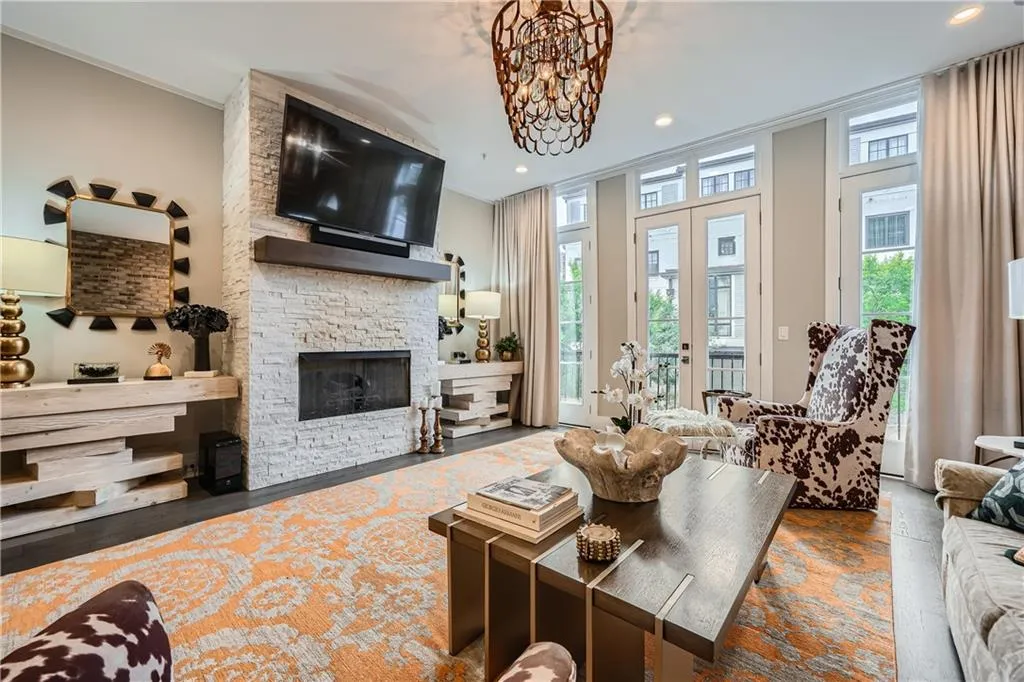Living room with wood finished floors, a fireplace, a chandelier, and recessed lighting