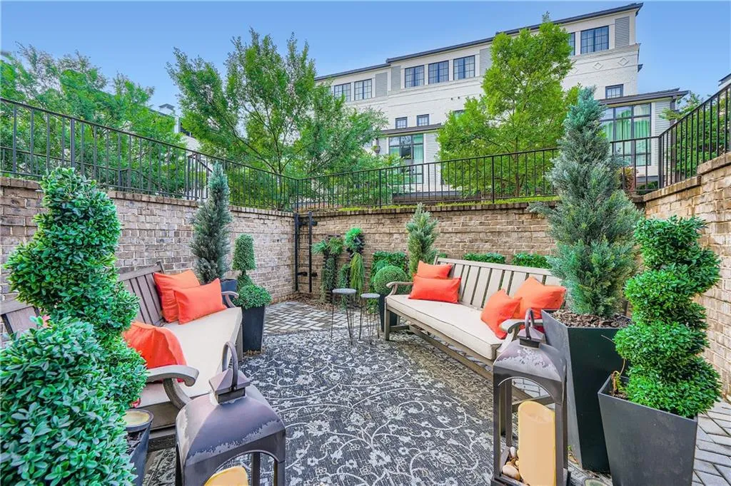 Fenced backyard with an outdoor hangout area and a patio