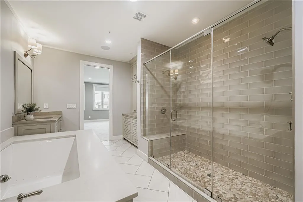 Full bathroom featuring vanity, a shower stall, and recessed lighting
