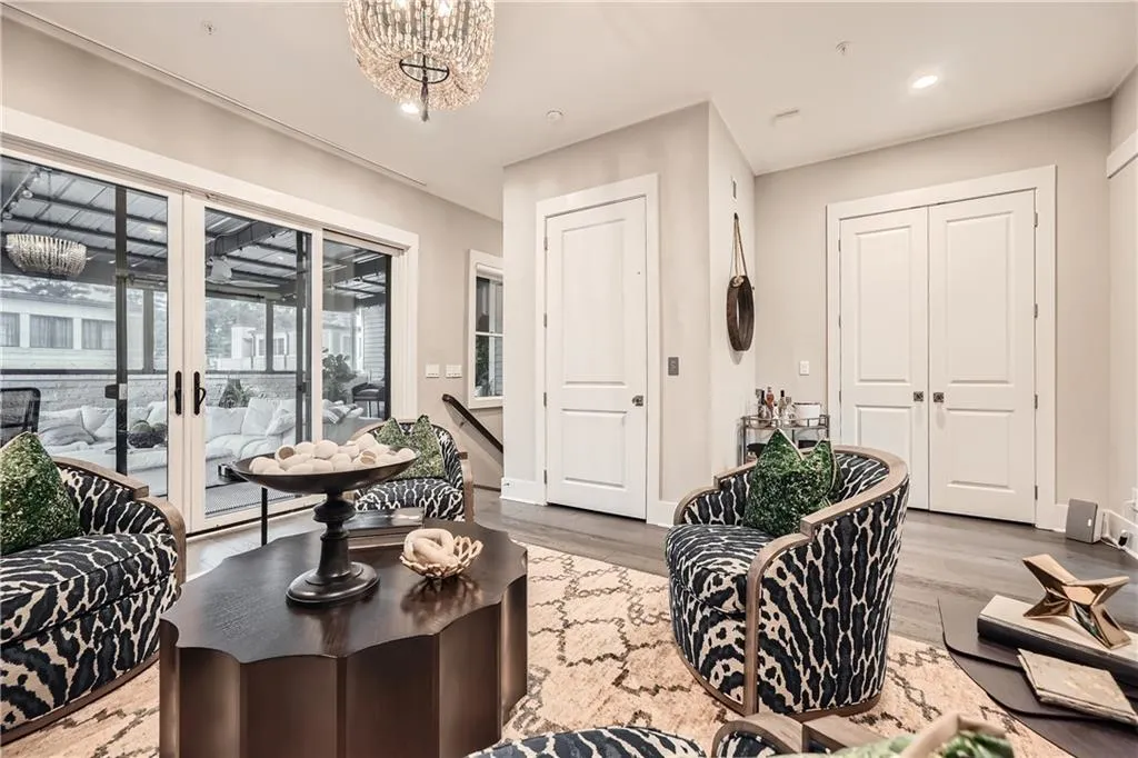 Living area featuring wood finished floors, a chandelier, and recessed lighting