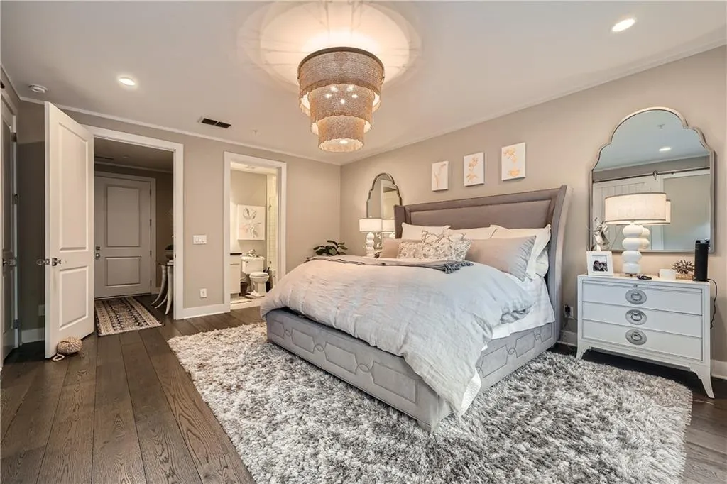Bedroom featuring dark wood-style flooring, ornamental molding, recessed lighting, and ensuite bath