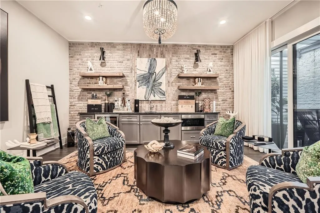Living area with brick wall, light wood-style flooring, beverage cooler, and recessed lighting