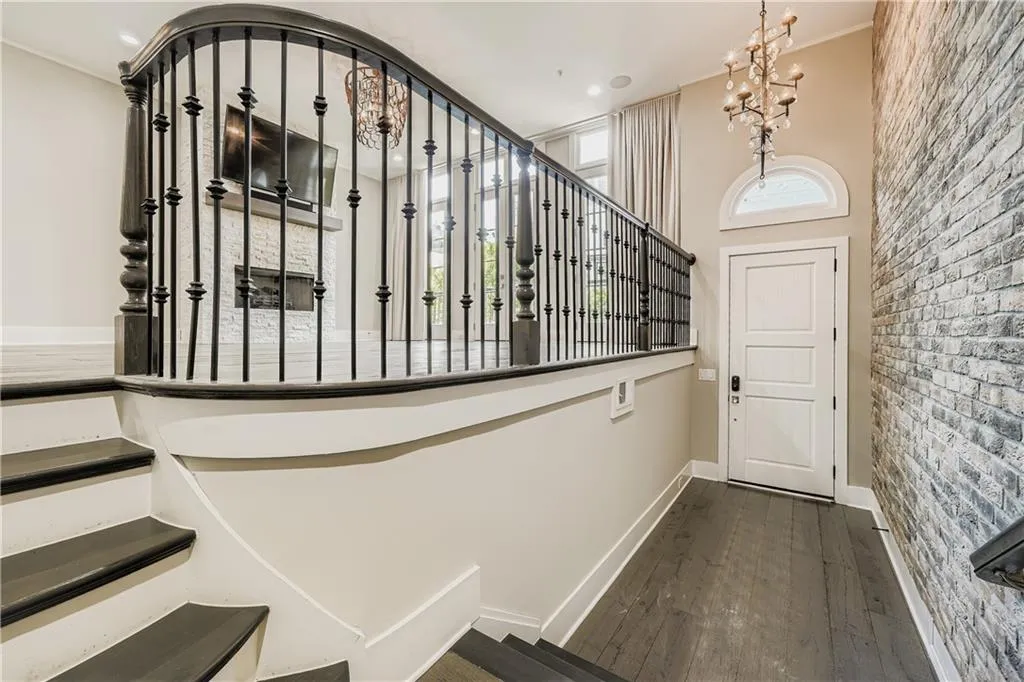 Staircase with wood-type flooring, a chandelier, and recessed lighting