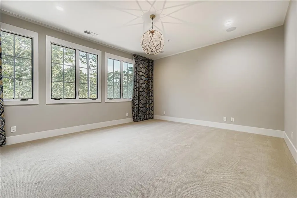 Empty room featuring light carpet and recessed lighting