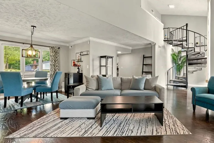 Expansive open concept living area with dark wood-finish flooring