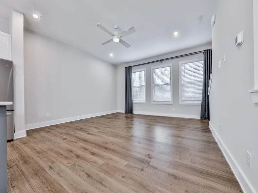 Unfurnished living room with light wood-style flooring, recessed lighting, and a ceiling fan