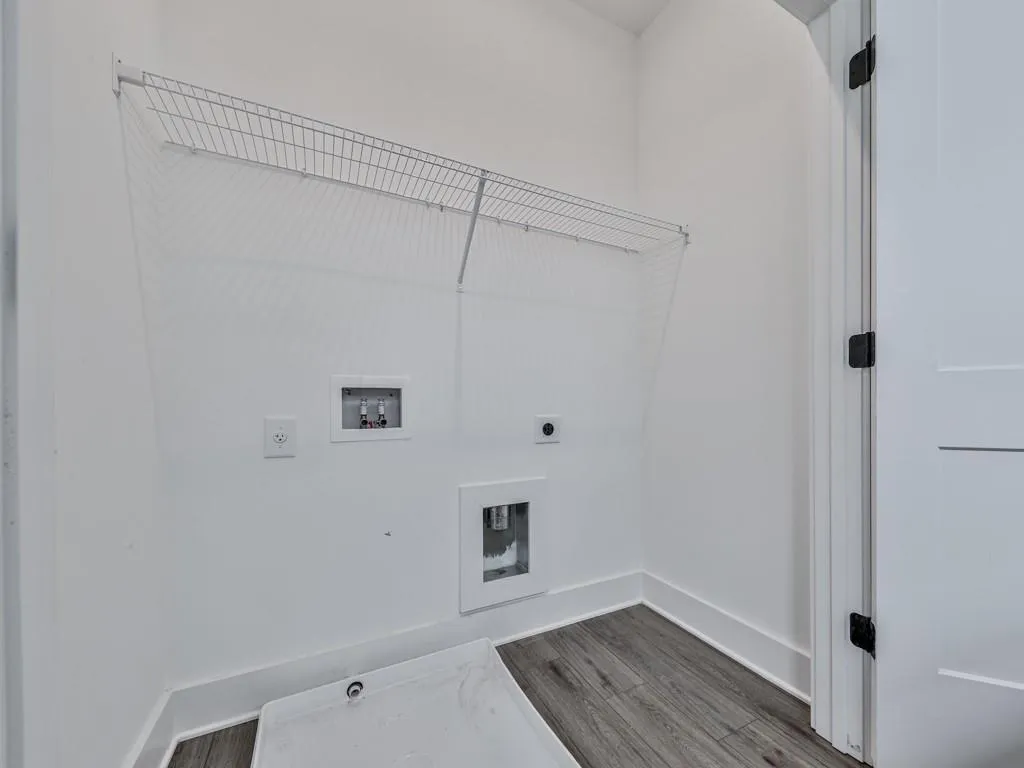 Laundry area with electric dryer hookup, washer hookup, and dark wood-style flooring