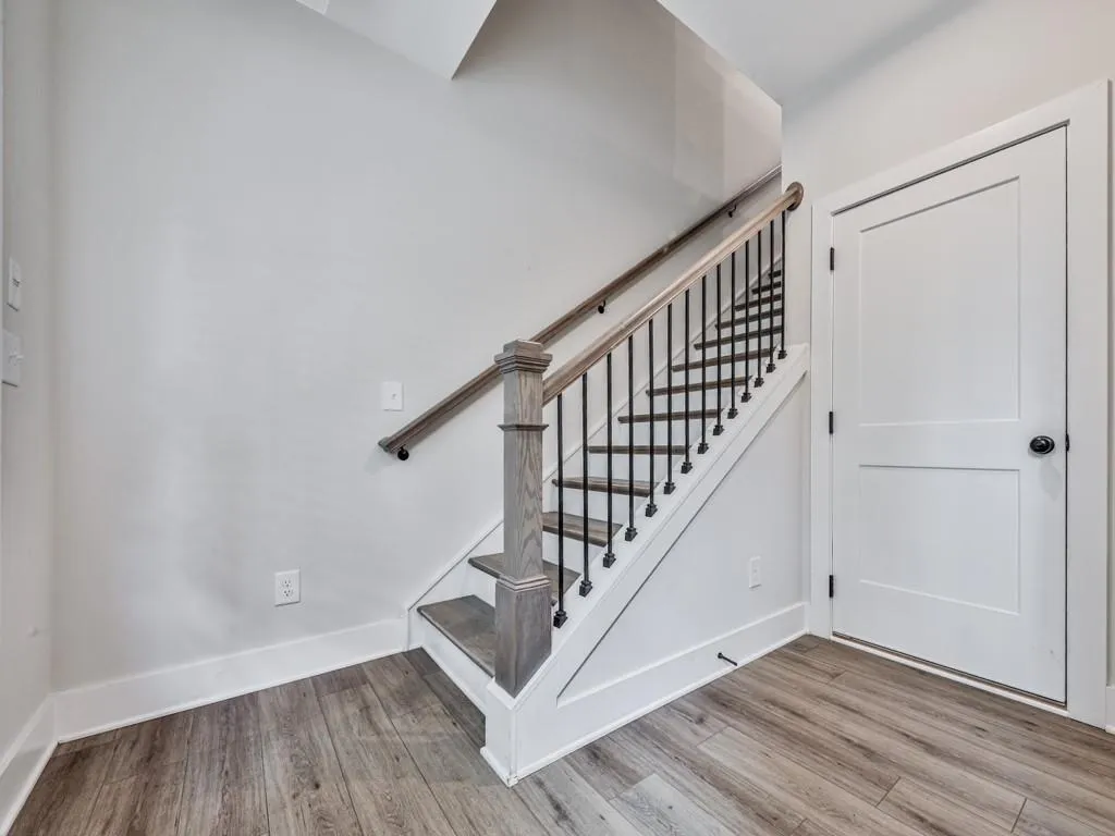 Stairway featuring LVP floors and baseboards