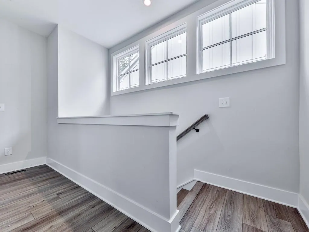 Stairs featuring baseboards and wood-style floors