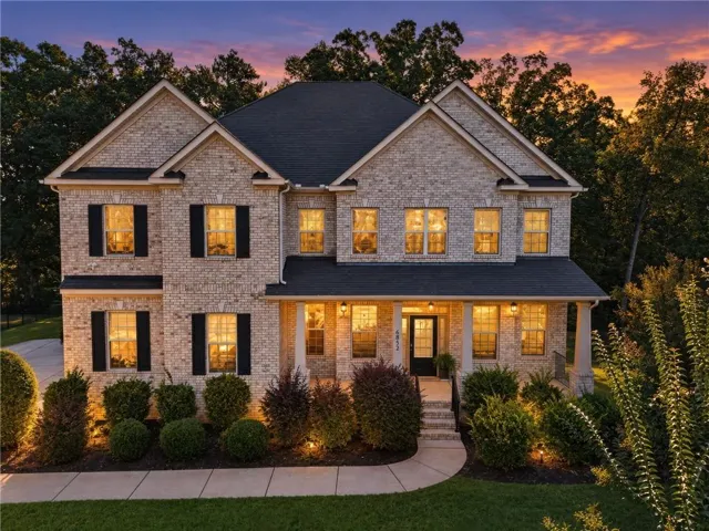 Two-story brick exterior with gabled roof lines and dark-colored shutters