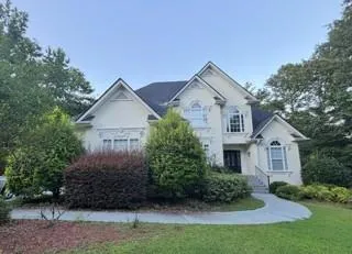 Stucco exterior with multiple gables and arched windows