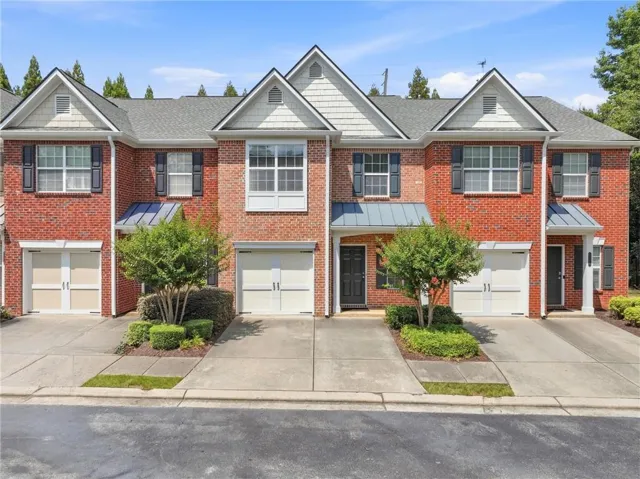 Red brick exterior with white trim accents and architectural gables