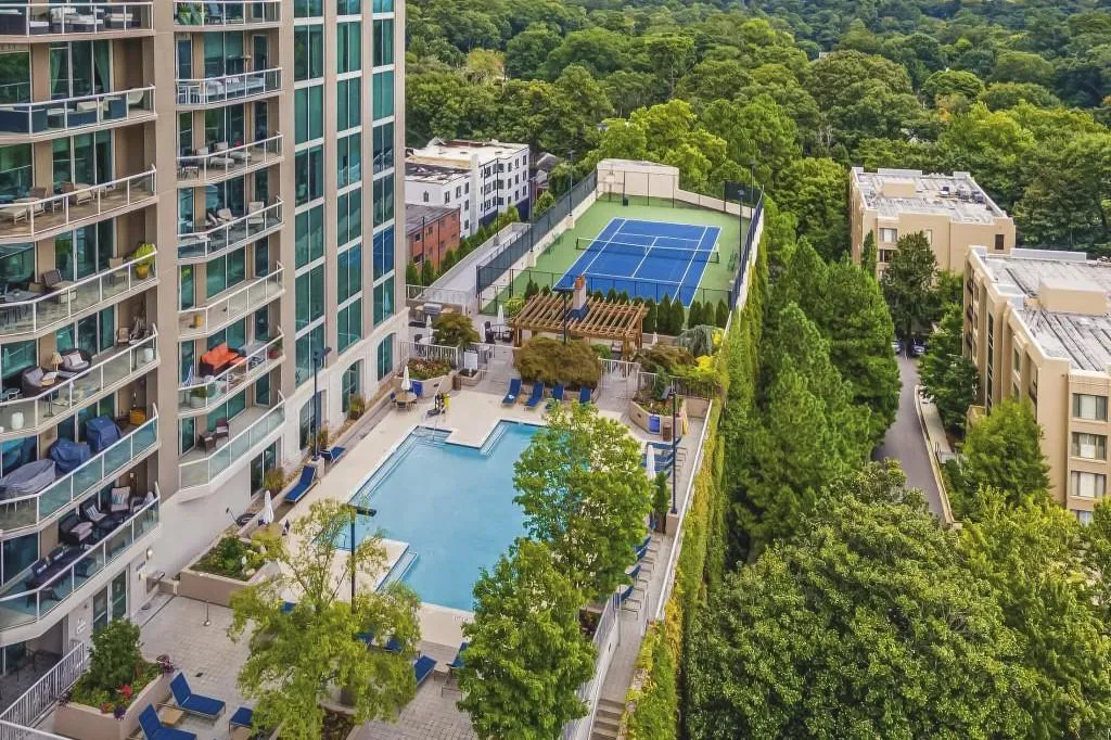 Amenities deck is home to the outdoor kitchen and grilling area, saltwater pool and tennis court.